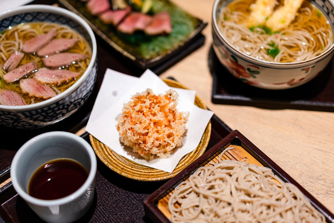 :serving chopsticks beside shared dishes at a japanese meal