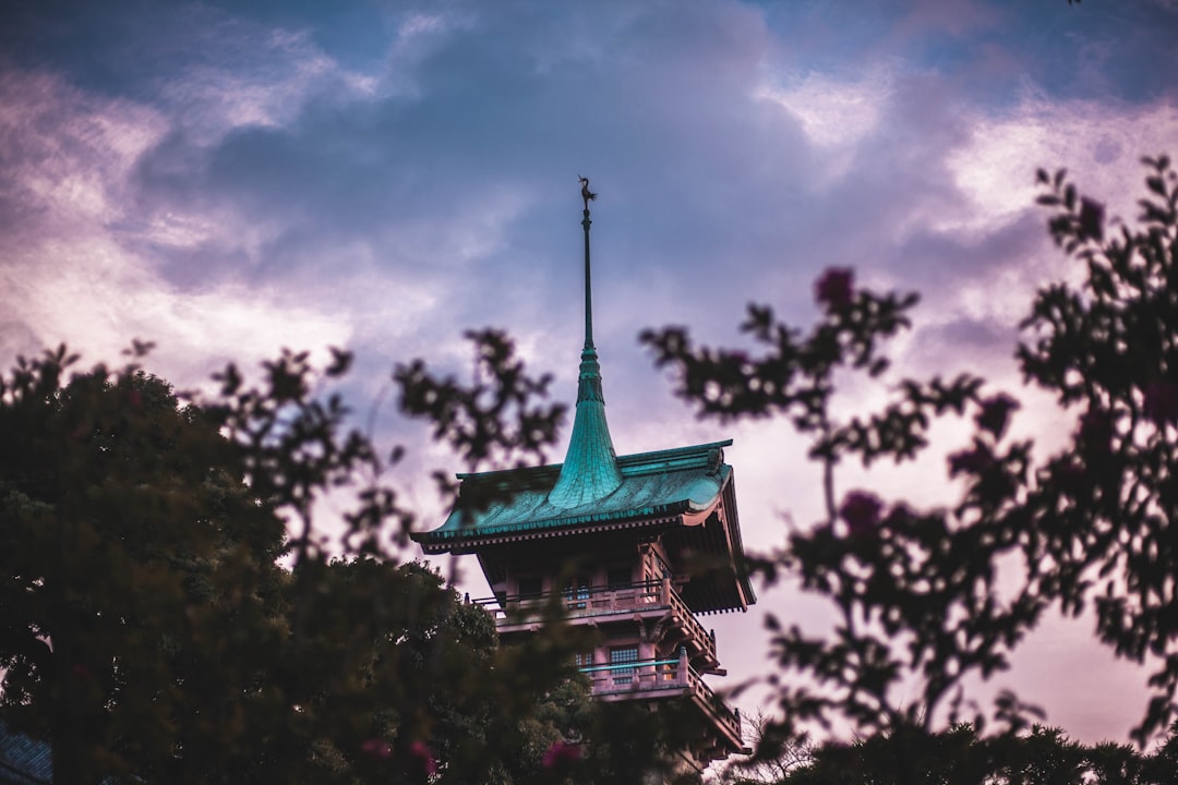 :dogo onsen honkan wooden bathhouse in matsuyama at dusk