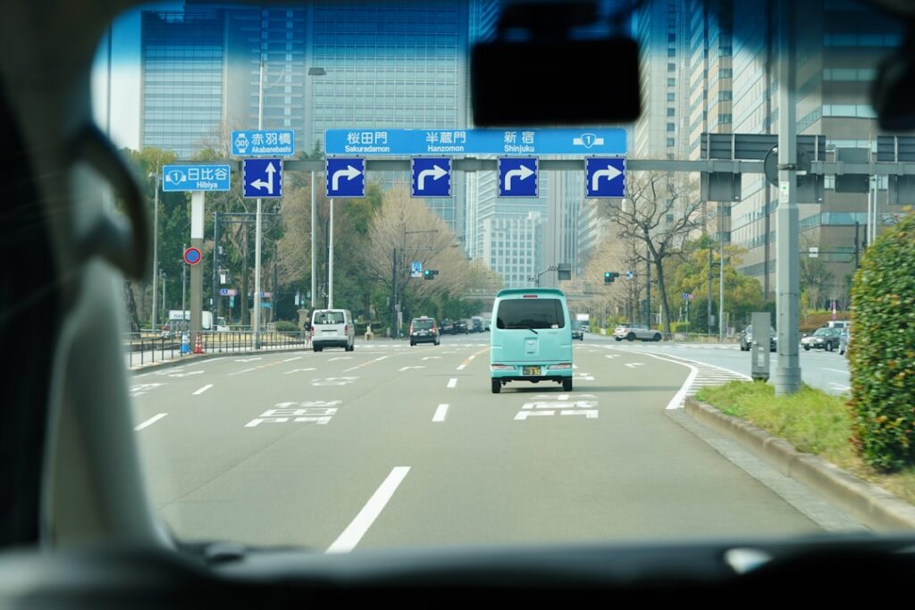 ：driving on a japanese road with bilingual directional road signs