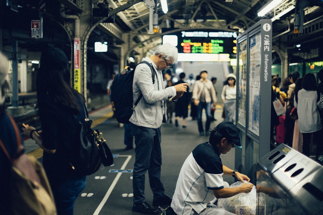 ：passengers queueing at marked positions on a japanese platform