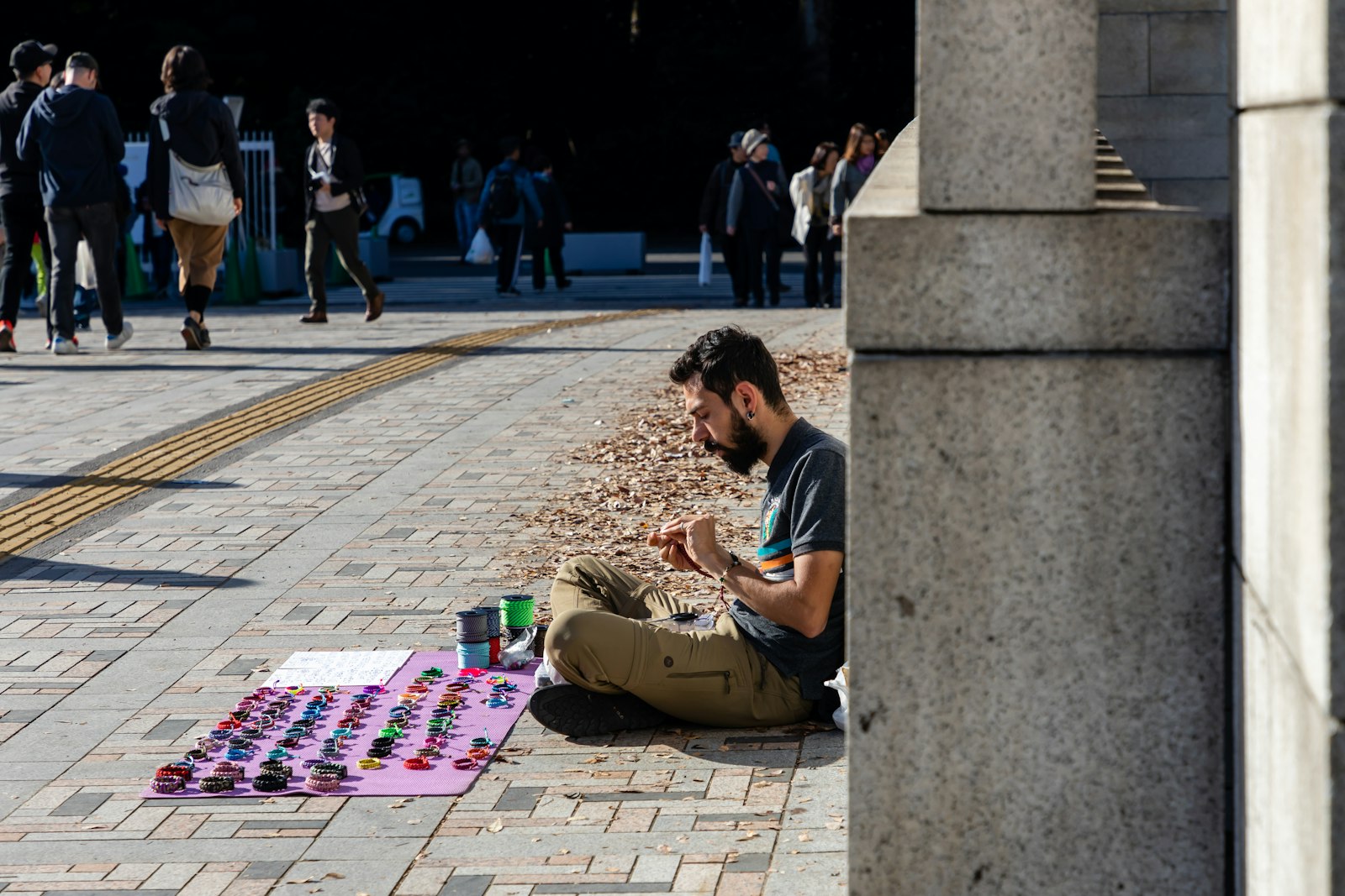 man in black t-shirt sitting on concrete bench