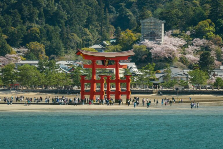 a large red tower sitting on top of a beach