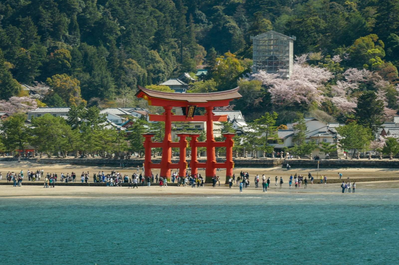 a large red tower sitting on top of a beach