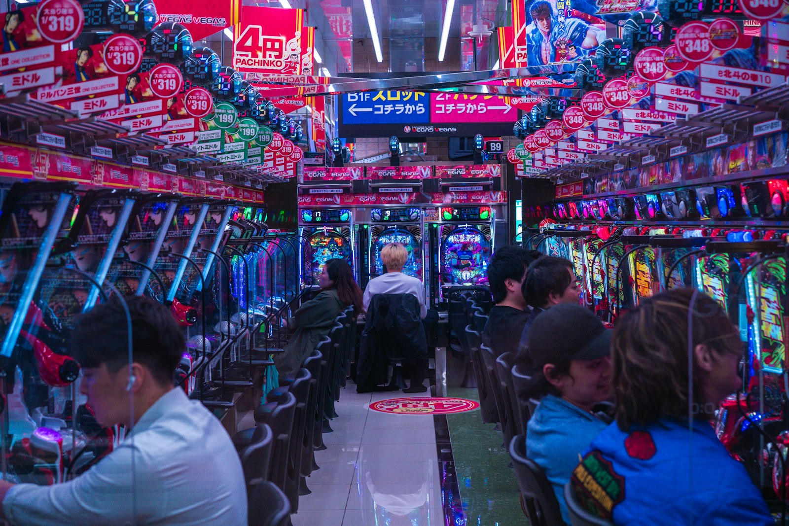 Vibrant pachinko parlor interior with people playing machines