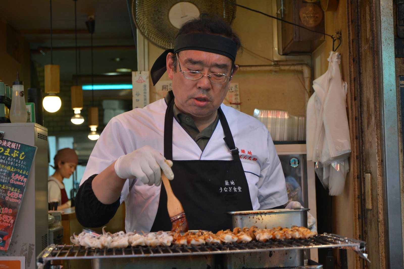 man in white chef uniform holding knife slicing meat