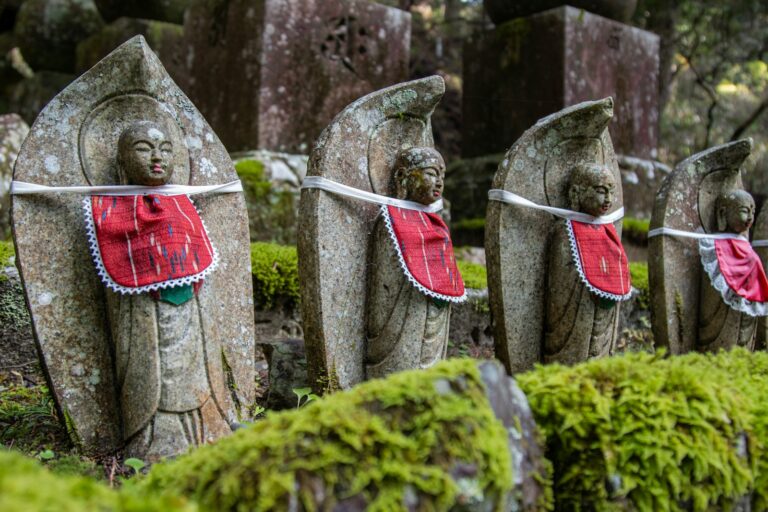a group of statues of people wearing clothing and holding swords