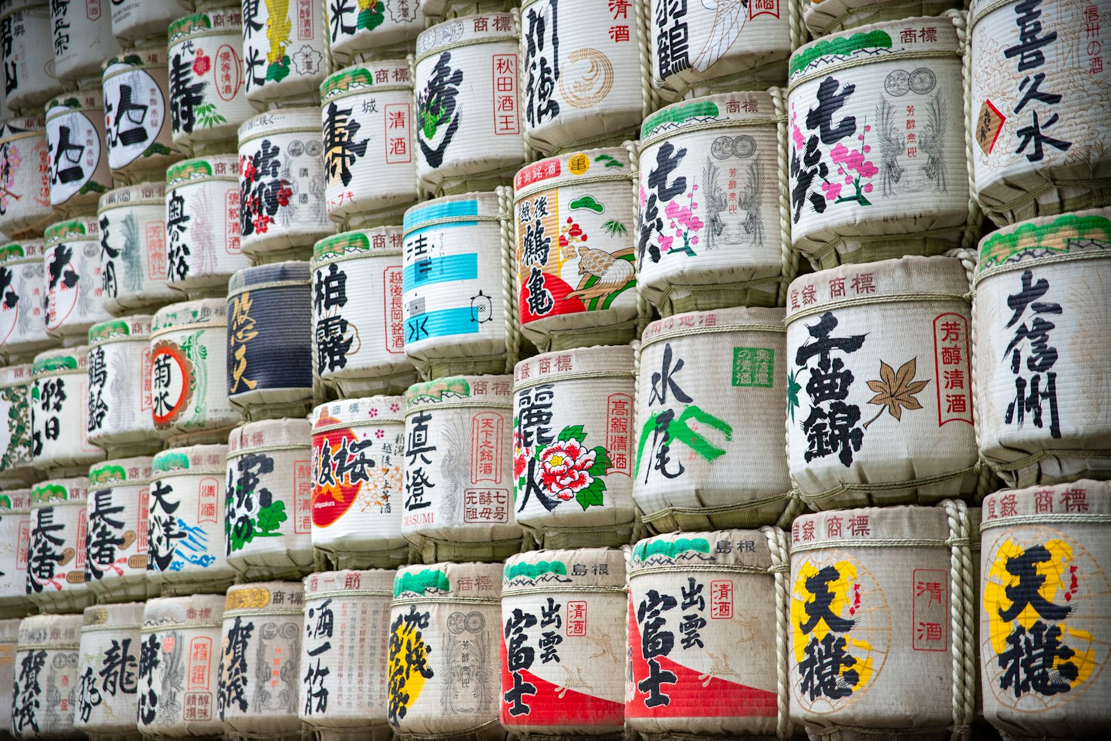 Wall of sake barrels with japanese writing and art