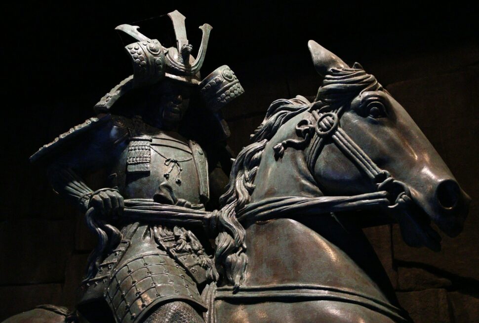 A bronze statue of a samurai warrior on horseback