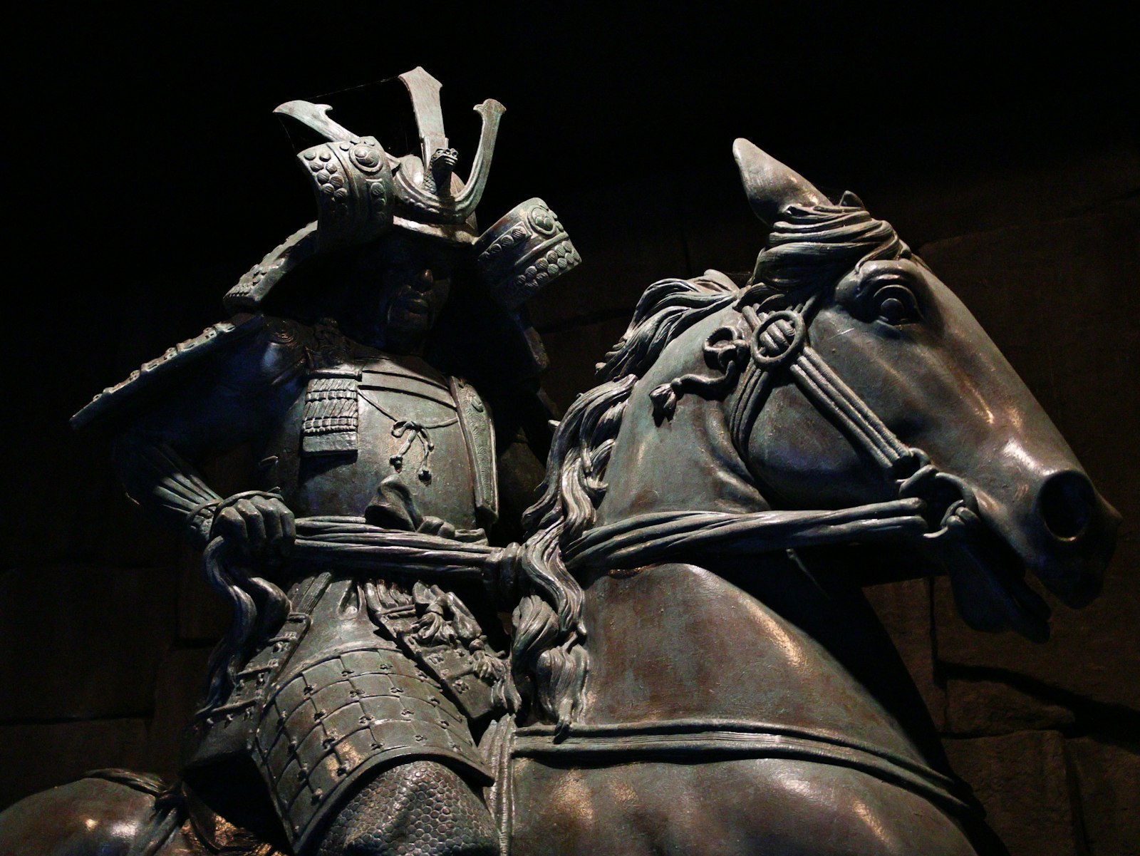 A bronze statue of a samurai warrior on horseback