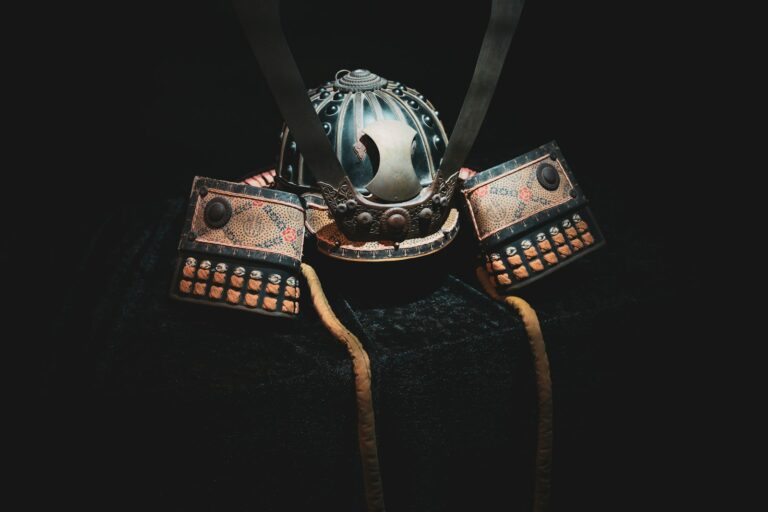 A detailed samurai helmet and armor in darkness