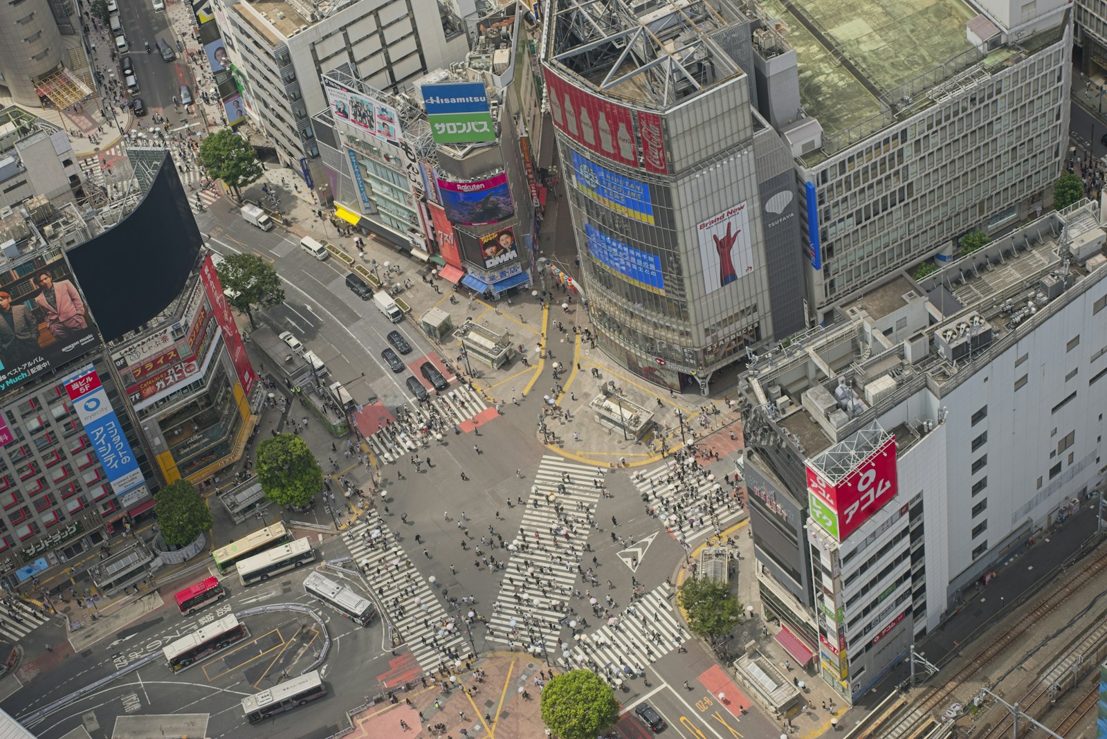 An aerial view of the Shibuya Crossing intersection with pedestrians and vehicles in Tokyo