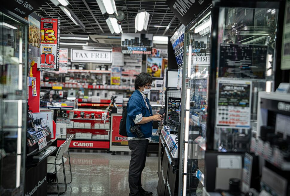 Person browsing electronics in a brightly lit store