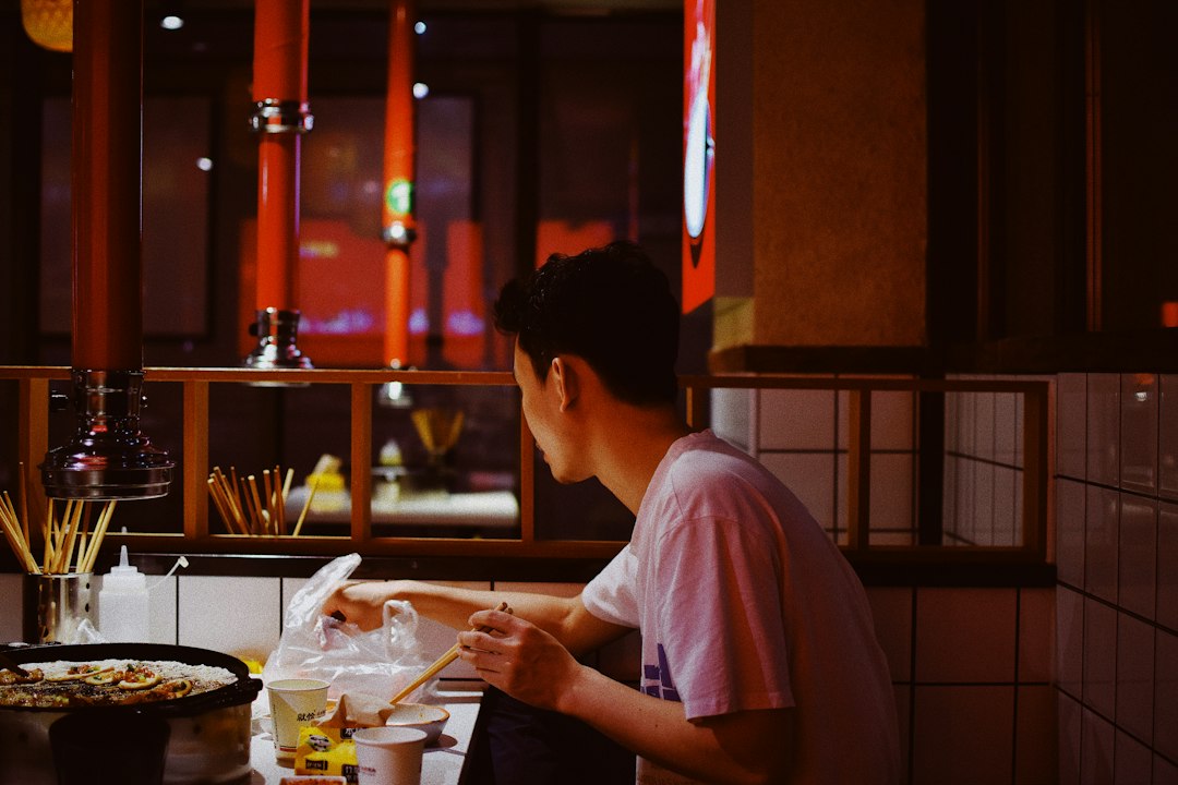 :solo diner eating late night ramen at a counter in shibuya