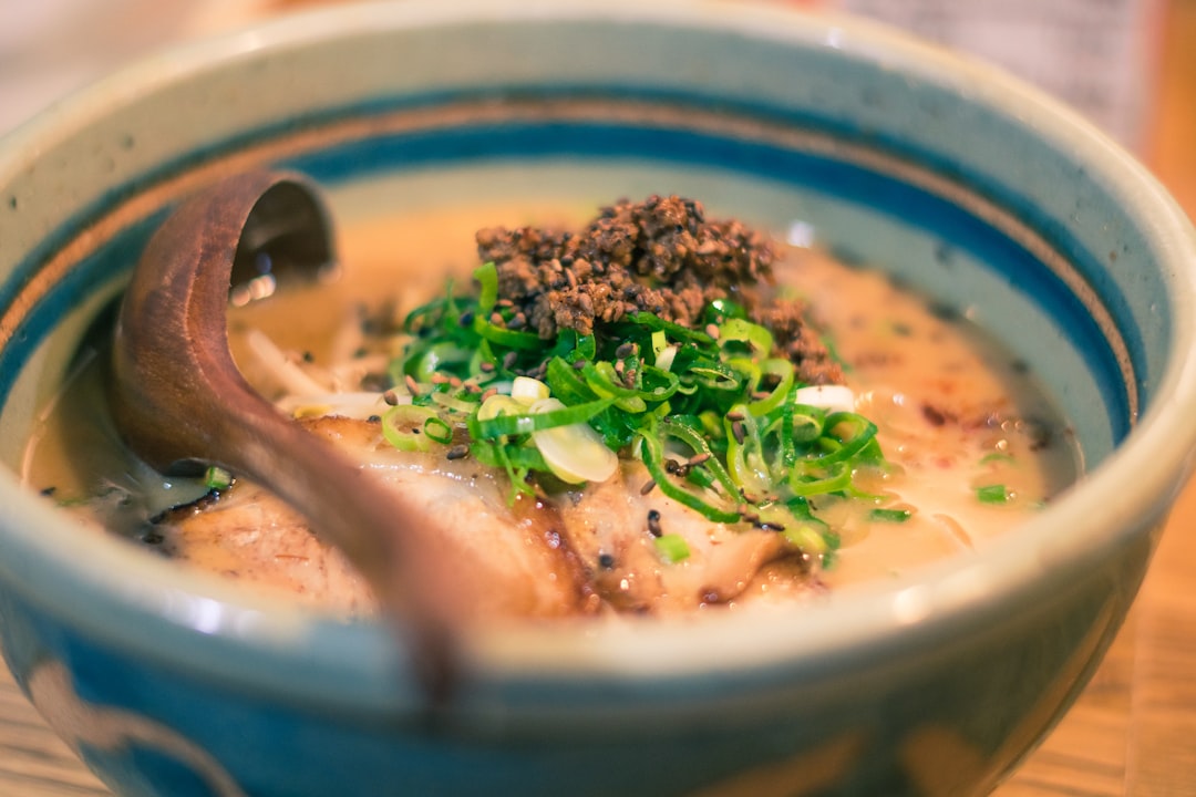 :a bowl of shoyu ramen at a counter shop in shibuya tokyo