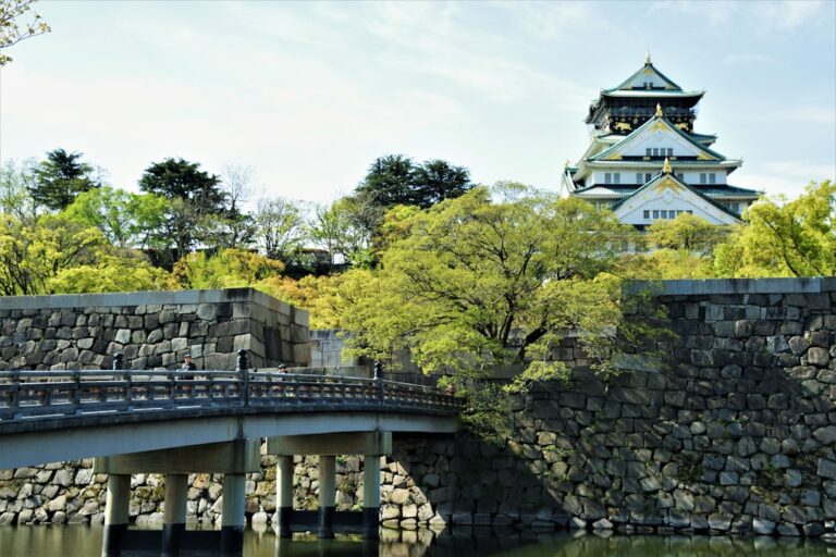 ：osaka castle main tower above its stone walls and moat