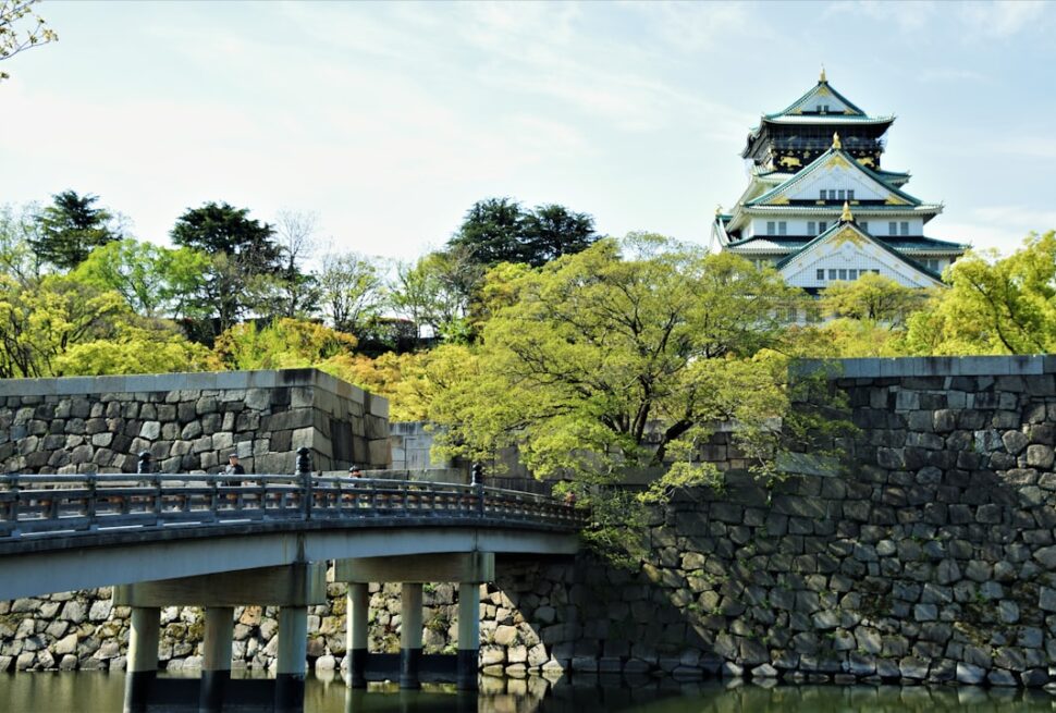 ：osaka castle main tower above its stone walls and moat