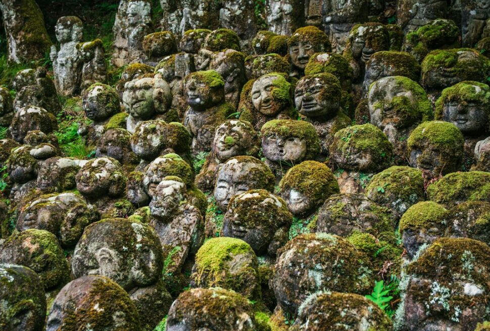 ：moss covered rakan statues at otagi nenbutsu-ji temple in kyoto