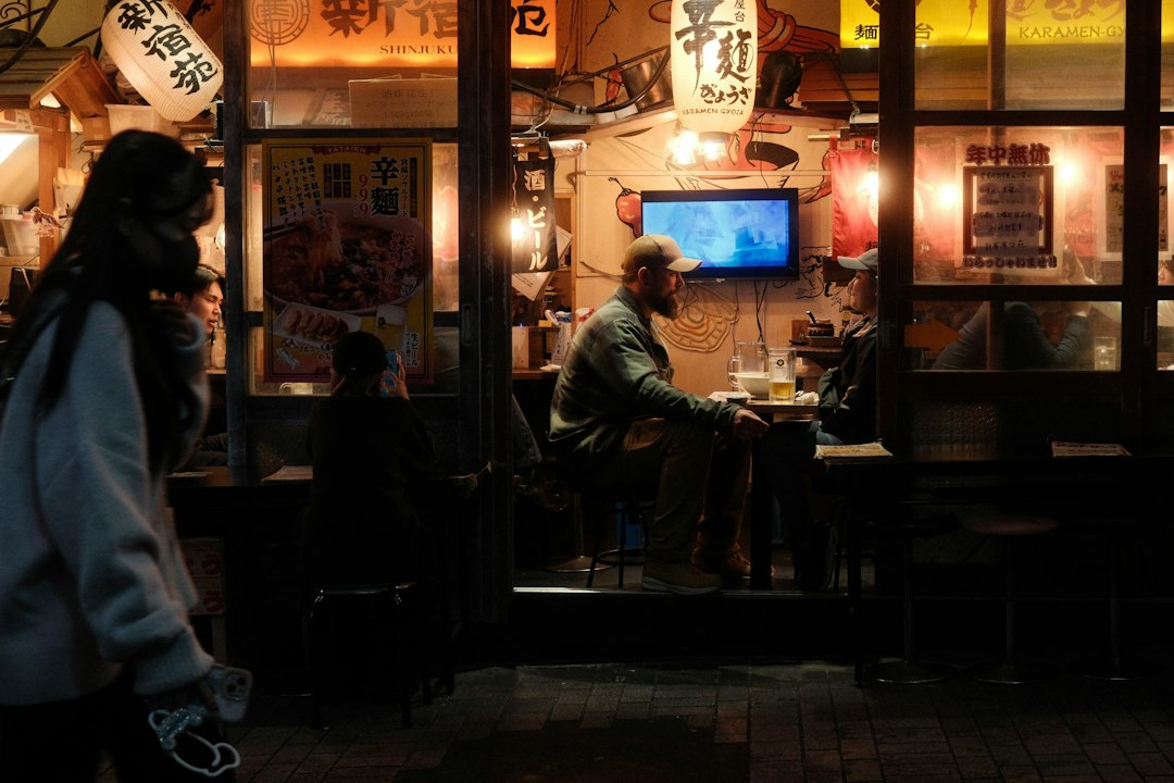 ：open fronted izakaya tables on hoppy street in asakusa in the evening