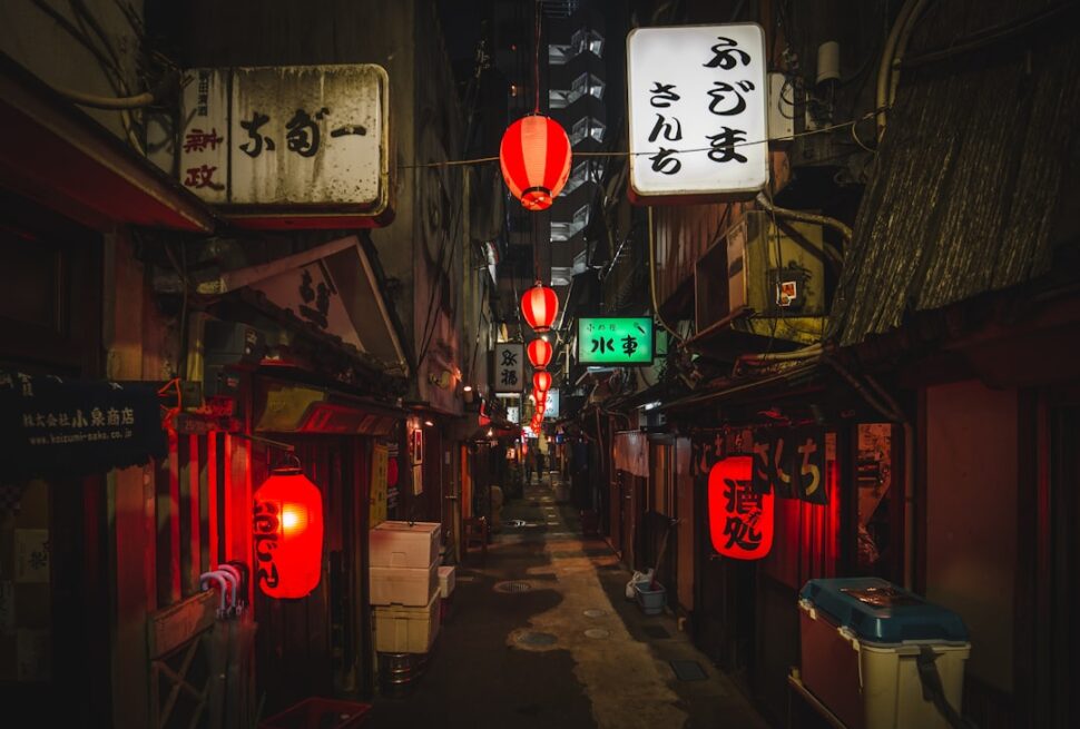 ：red lanterns over the narrow lane of nonbei yokocho in shibuya at night