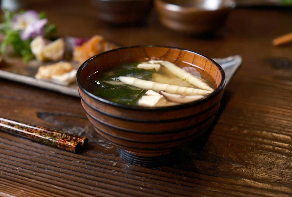 ：what is miso soup a lacquer bowl with tofu wakame and green onion