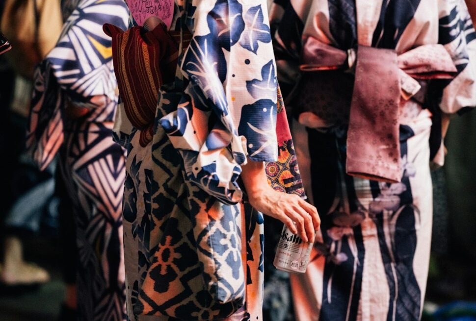 ：different types of kimonos displayed on a rack in a japanese shop