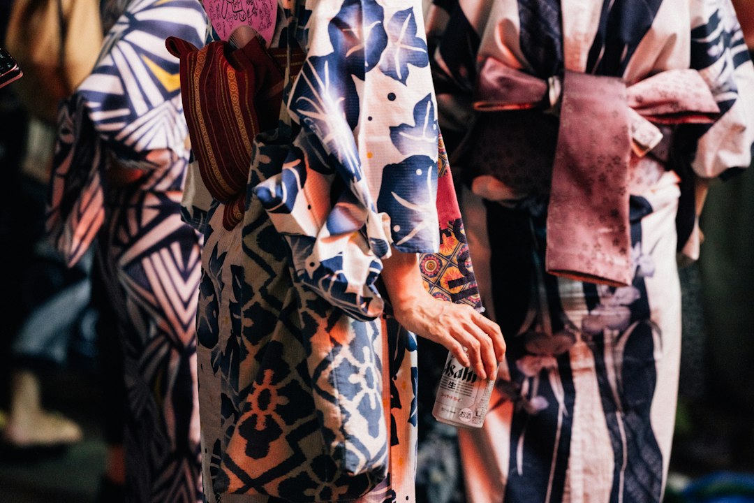 :different types of kimonos displayed on a rack in a japanese shop