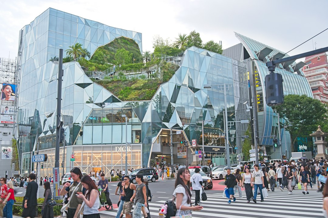 :glass diamond grid facade of a modern building near omotesando tokyo