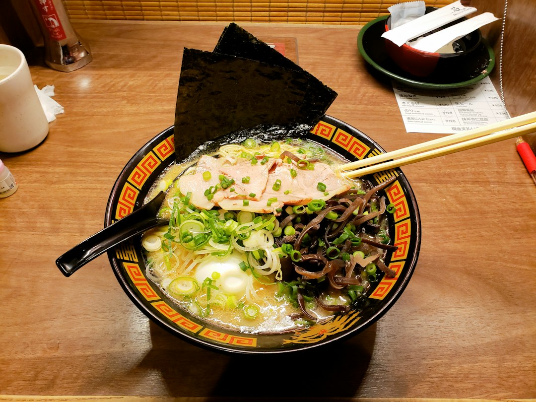 :a bowl of sapporo ramen with miso broth, corn and butter
