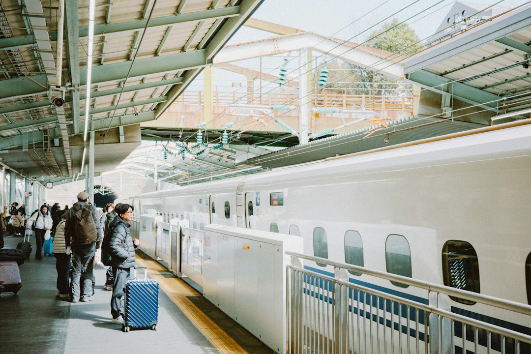 :passengers boarding the shinkansen at shin-osaka station