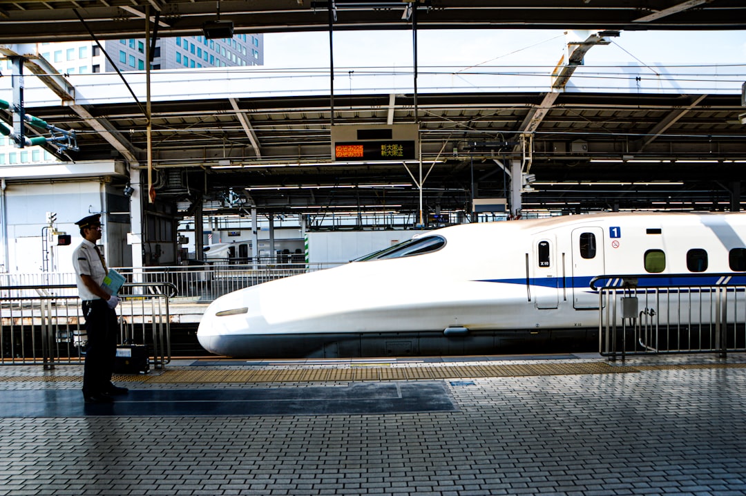 :shinkansen arriving at a platform in japan