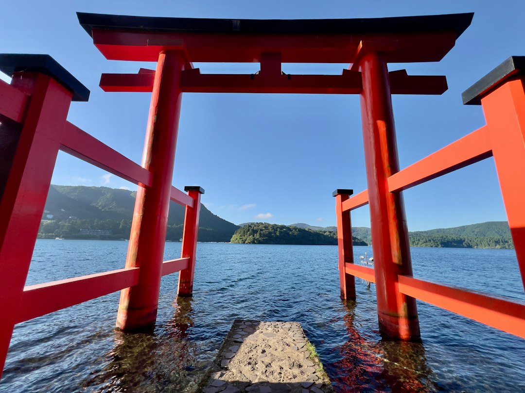 :the lakeside torii gate of hakone shrine on lake ashi