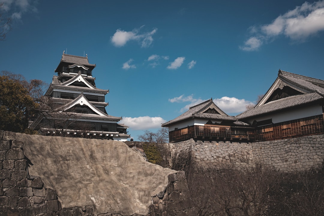 :kumamoto castle keep above its curved musha-gaeshi stone walls