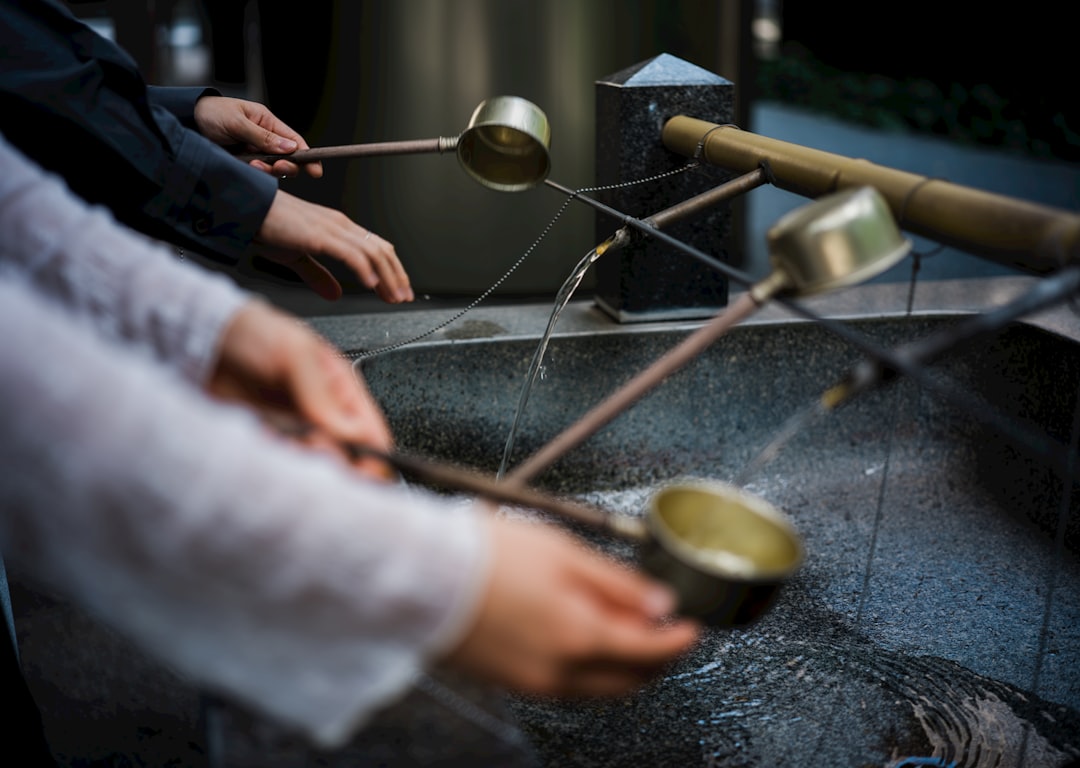 :purifying hands at the temizuya water basin of a kyoto shrine
