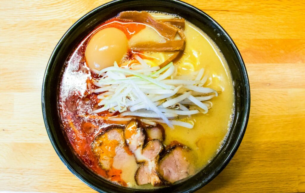 :a bowl of shinjuku ramen served at a tokyo noodle counter